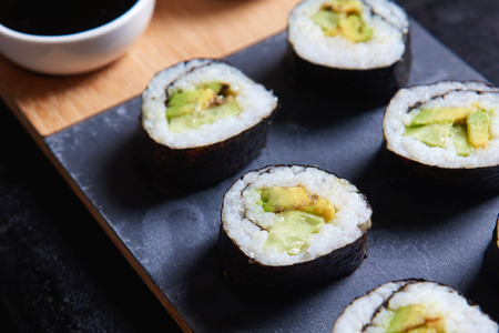 Vegan sushi rolls made with nori algae, sushi rice, cucumbers and avocadoの写真素材