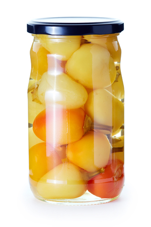 Pickled preserved bell peppers in a jar isolated on white backgroundの写真素材