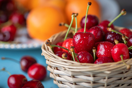 Close up of fresh ripe cherries in woven basket
