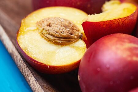 Fresh ripe nectarines on blue rustic wooden backgroundの写真素材