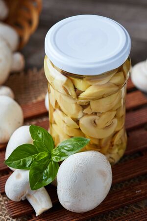 Marinated pickled champignon mushrooms (Agaricus bisporus) in jarの写真素材