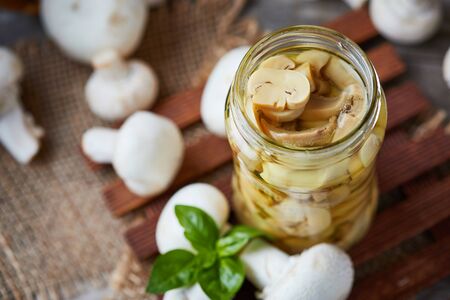 Marinated pickled champignon mushrooms (Agaricus bisporus) in jarの写真素材