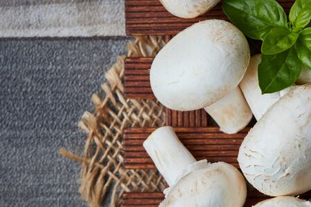 Raw organic champignon mushrooms (Agaricus bisporus). Top view with copy space