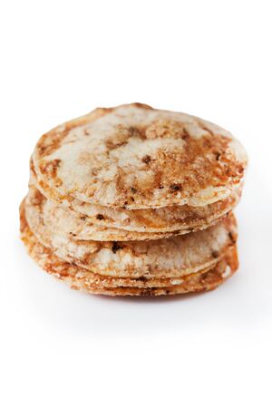 Brown rice chips isolated on white background. Healthy crispy snackの写真素材
