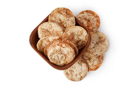 Brown rice chips isolated on white background. Healthy crispy snackの写真素材