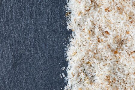 Psyllium (ispaghula) husk on black rustic background. Top view with copy spaceの写真素材