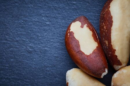 Close up of brazil nut (Bertholletia excelsa) on black background. Top view with copy space