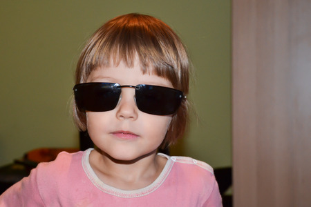 Little girl with oversized sunglassesの写真素材