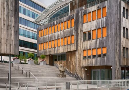 Oslo, Norway - July 18, 2016: People enjoying the summer sunshine beside the al fresco restaurants and modern apartment buildings of Aker Brygge, the popular leisure district on the Oslo waterfront overlooking the marinas of Oslofjrden, Norway.のeditorial素材