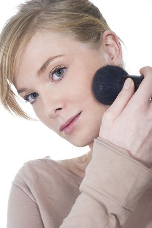 Portrait of a young woman doing makeup