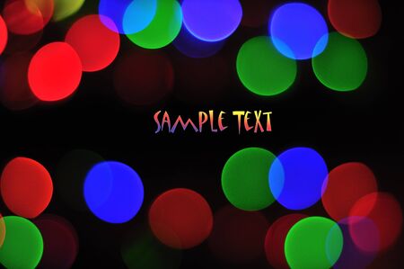 Abstract holiday background with circular lights of different color and space for your textの写真素材
