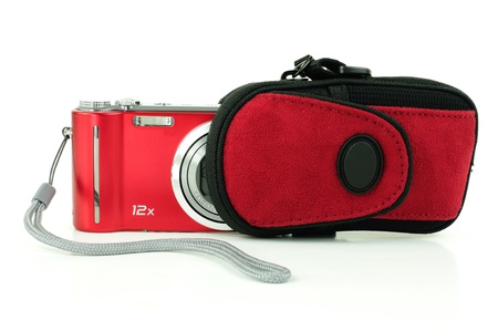 Small red compact digital camera being stored in a pouch for protection