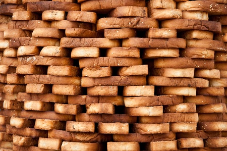 Delicious cookies made of sesame seeds stacked for sale at an Indian marketの写真素材