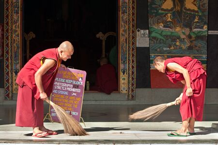 SIKKIM, INDIA - OCTOBER 27: Tibetan monks clean the monastery floor before start of morning prayer ceremony at Rumtek on October 27, 2011 in Sikkim, India. Rumtek is the largest monastery in Sikkim.のeditorial素材