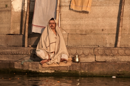 VARANASI, INDIA - FEBRUARY 19, 2012: A Hindu brahmin monk meditates on the bank of holy Ganges river on the auspicious Maha Shivaratri festival on February 19, 2011 at Varanasi, Uttar Pradesh, Indiaのeditorial素材