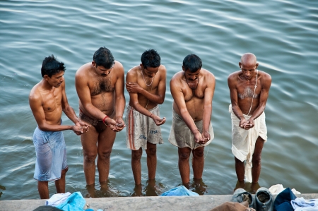 VARANASI, INDIA - FEBRUARY 18, 2012: Hindu pilgrims offer prayers on the bank of holy Ganges river on the auspicious Maha Shivaratri festival on February 18, 2011 at Varanasi, Uttar Pradesh, India.のeditorial素材