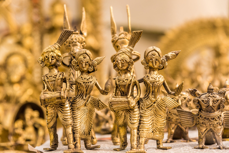 Beautiful golden dolls made of brass of miniature folk musicians performing in a band of classical Indian musicの写真素材