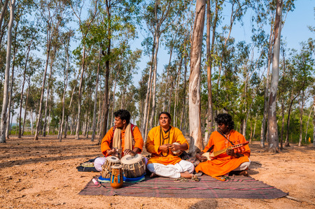 SHANTINIKETAN, INDIA - DECEMBER 22: An Indian traditional baul folk band performs during the annual Poush Mela fair on December 22, 2012 in Shantiniketan, West Bengal, India.のeditorial素材