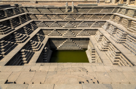The famous ancient Stepped Tank in Hampi, excavated from ruins of 14th century Vijayanagara kingdom.の写真素材