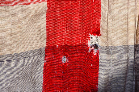 Old and worn clothes hang on the clothes line.