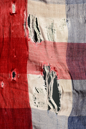 Old and worn clothes hang on the clothes line.の写真素材