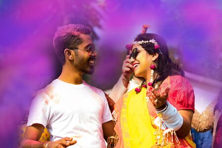 Indian Couple Dancing and Playing With Colors in Indian Festival Holi