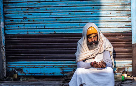 Pushkar,Rajasthan /India. 06 /11/2019. Indian Beggar on streets in Early morning lighting the Cigaretのeditorial素材