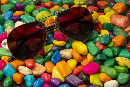 Sunglasses on colour stoneの写真素材