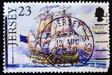 JERSEY - CIRCA 2004: A stamp printed in Jersey showing a sailing ship with the flag of United Kingdom, circa 2004 の写真素材