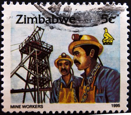 ZIMBABWE - CIRCA 1995: A stamp printed in Zimbabwe shows mine workers, circa 1995の写真素材