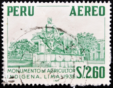 PERU - CIRCA 1935: A stamp printed in Peru shows monument to the indigenous farmer, circa 1935 の写真素材
