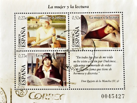 SPAIN - CIRCA 2004: A stamp printed in Spain shows images related to women and reading, circa 2004 の写真素材