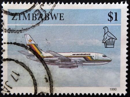 ZIMBABWE - CIRCA 1990: A stamp printed in Zimbabwe shows an aircraft in flight, circa 1990の写真素材
