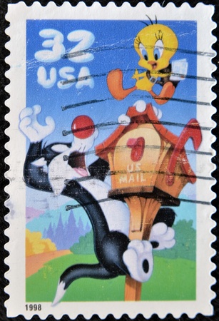 UNITED STATES OF AMERICA - CIRCA 1998: A stamp printed in USA shows Sylvester and Tweety, circa 1998 のeditorial素材