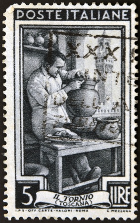 ITALY - CIRCA 1950: A stamp printed in Italy dedicated to the works of pottery on the wheel, Toscana, Circa 1950の写真素材