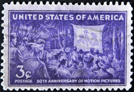 UNITED STATES OF AMERICA - CIRCA 1944: A stamp printed in USA dedicated to 50th anniversary of motion pictures, circa 1944の写真素材