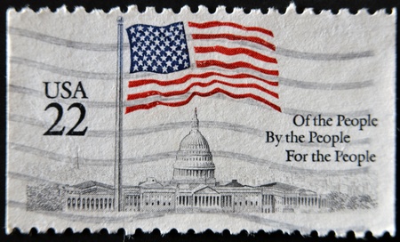 UNITED STATES OF AMERICA - CIRCA 1985: A stamp printed in the USA shows Flag over Capitol, circa 1985 の写真素材