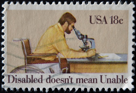USA - CIRCA 1981: A stamp printed in USA shows Man Looking through Microscope, and the inscription "Disabled doesnt mean unable" devoted of International Year of the Disabled , circa 1981 の写真素材