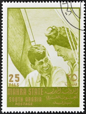 SOUTH ARABIA - CIRCA 1967: stamp printed by South Arabia, shows John Fitzgerald Kennedy and Jacqueline, circa 1967のeditorial素材