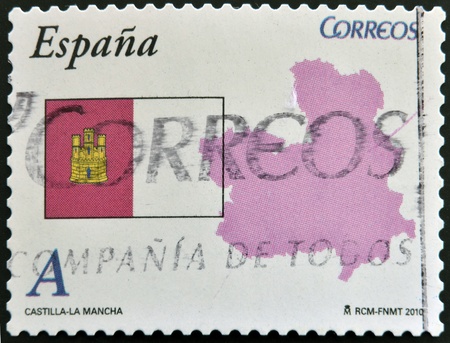 SPAIN - CIRCA 2010: A stamp printed in spain shows flag and map of the autonomous community of Castilla La Mancha, circa 2010の写真素材