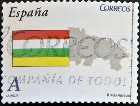 SPAIN - CIRCA 2010: A stamp printed in spain shows flag and map of the autonomous community of La Rioja, circa 2010の写真素材