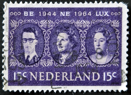 HOLLAND - CIRCA 1964: a stamp printed in the Netherlands shows King Baudouin, Queen Juliana and Grand Duchess Charlotte, Benelux, circa 1964 のeditorial素材