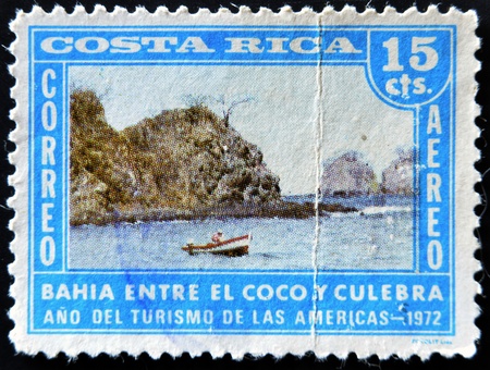 COSTA RICA - CIRCA 1972: A stamp printed in Costa Rica dedicated to the year of tourism in the Americas, shows the Bay between the coconut and snake, circa 1972のeditorial素材