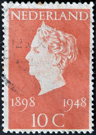 HOLLAND - CIRCA 1948: A stamp printed in Netherlands shows queen Wilhelmina, circa 1948のeditorial素材