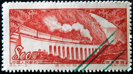 CHINA - CIRCA 1952: A stamp printed in china shows passenger train with steam locomotive on the railroad viaduct Chungking-Chengtu, circa 1952のeditorial素材