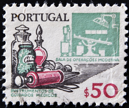 PORTUGAL - CIRCA 1970: A stamp printed in Portugal shows medical instruments and modern operating room, circa 1970のeditorial素材