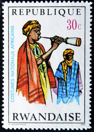 RWANDA - CIRCA 1970: A stamp printed in Rwanda shows African national dress, circa 1970の写真素材