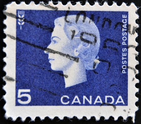 CANADA - CIRCA 1962: A stamp printed in Canada showing a portrait of Queen Elizabeth II and Agriculture symbol, circa 1962. のeditorial素材
