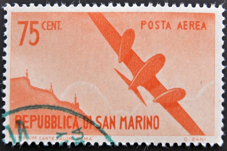 SAN MARINO - CIRCA 1950: A stamp printed in San Marino shows aircraft in flight, circa 1950のeditorial素材