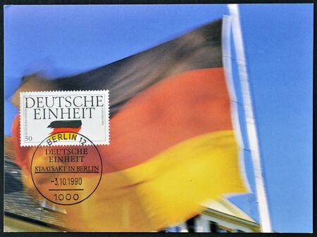GERMANY - CIRCA 1990  A postcard printed in Germany dedicated to German Reunification, shows flag, circa 1990 のeditorial素材